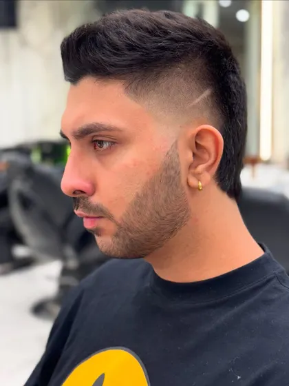 It's all about the details in men's grooming. Here's a look at a sharp, modern fade with a precise design line, showcasing our skill in creating clean, stylish, and personalized haircuts for men.