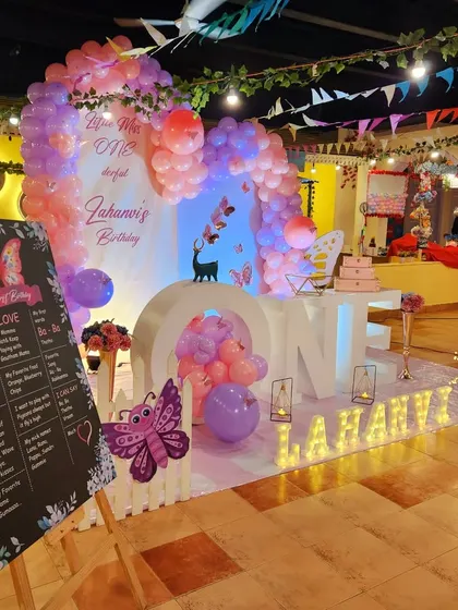 This butterfly-themed first birthday includes a personalized milestone board sharing all of the baby's favorite things.