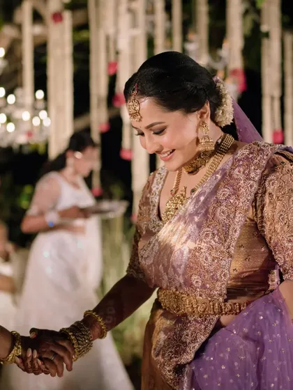The bride greeting guests with a warm handshake during her wedding ceremony.