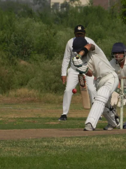 A batsman fully focused, playing a classic shot during a competitive match. Our tournaments are designed to give you the feel of real, high-quality cricket, moving beyond net practice.
