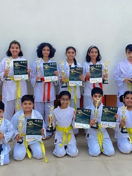 The next generation of champions. Our yellow belt students pose with their instructor, celebrating their victories and achievements at the Independence Day Cup.
