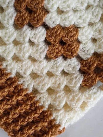 A close-up of the diamond granny stitch pattern. It's a fun variation that adds a geometric element to the traditional granny square look.