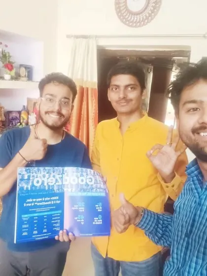 Our team takes a selfie with two customers holding our "GoodZero" brochure.