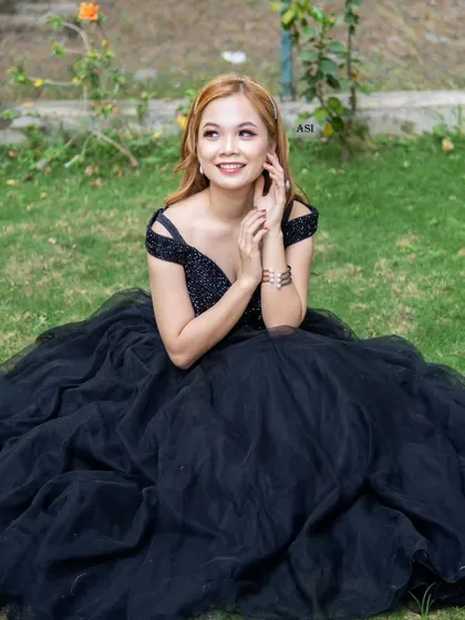 A beautiful portrait in our black off-shoulder ballgown. The sequined bodice and full tulle skirt create a classic and elegant look.