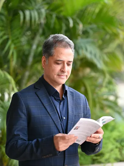 A candid-style shot of the author reading his own book. This type of photo helps to build a connection between the author and their work.