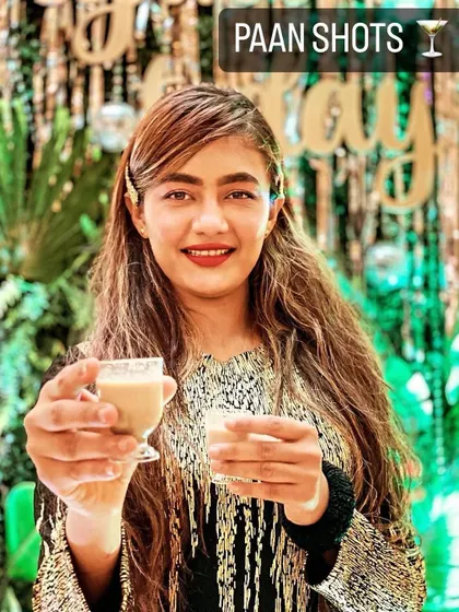 A guest enjoying our signature Paan Shots, a creative and refreshing mouth freshener to end the meal.