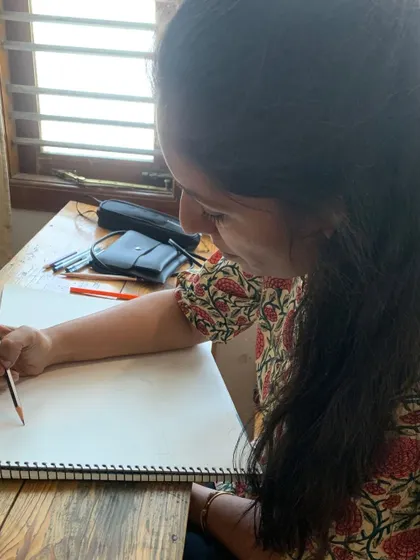 A student smiles as she sketches, finding joy in the process of learning and creating. This is what our Gurukul is all about.