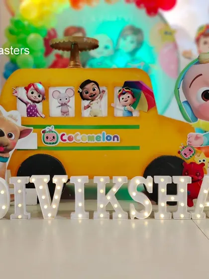 Personalization is key. We created custom light-up letters for the birthday girl's name, placed right in front of the Cocomelon bus prop for a perfect photo opportunity.