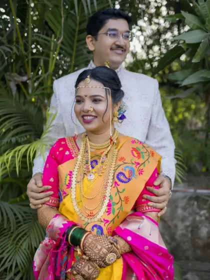A classic portrait of the Maharashtrian bride and groom, showcasing her stunning Paithani saree and traditional jewelry.