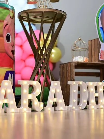 Another example of personalized LED name signs, this time for "AARADHYA" at a Cocomelon party. The bright lights make the name stand out beautifully in photos.