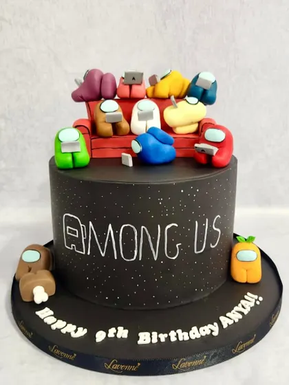 An "Among Us" cake for a 9th birthday party. We recreated the iconic characters hanging out on the couch, all made from fondant. It was fun figuring out who the imposter was!