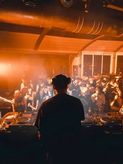 A view from behind the decks at a club, looking out at a full dance floor. This is the perspective from which I read the room and guide the night.