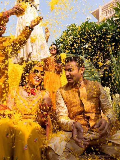 A Haldi ceremony is all about joy, and this moment captures it perfectly. I designed a vibrant, monochrome yellow setting, and seeing the couple showered in marigold petals is what makes my work so rewarding. It’s about creating the perfect backdrop for beautiful memories.