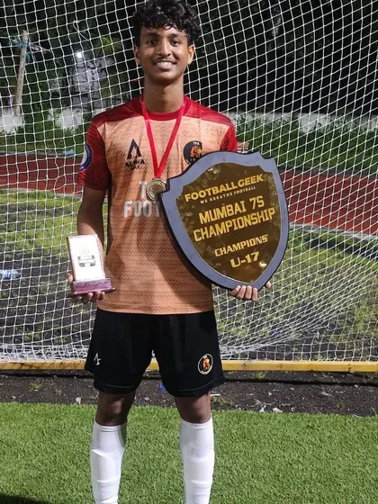A TFA player proudly displaying his championship trophy from the Mumbai 7s Championship Cup.