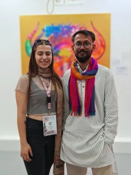 We facilitate meaningful connections at our World Art Dubai booth. Here, one of our represented artists, JD Passika, engages with a visitor about his spiritual art collection.