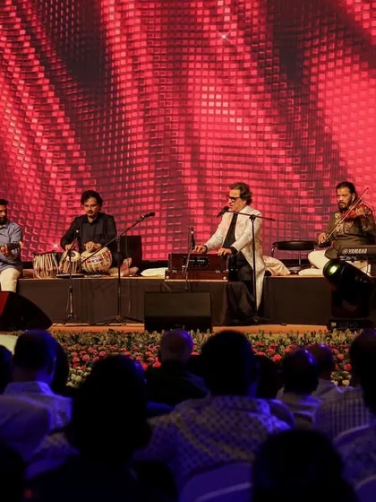 The full band on stage during a seated concert. This type of performance is perfect for corporate gatherings and private events that require a touch of elegance.
