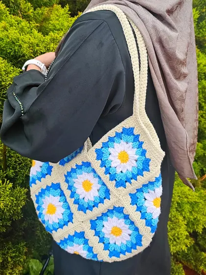 Here’s how the Daisy Tote looks styled with an abaya. The neutral strap and vibrant floral pattern make it a versatile accessory that adds a touch of cottagecore style to any look.