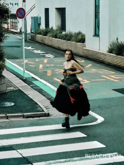 Capturing motion on the streets of Tokyo. The blur of the model running across the crosswalk creates a sense of urgency and energy.