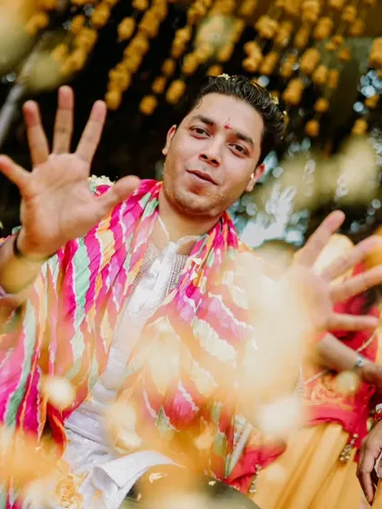 A guest or family member dances with joy during the Haldi celebrations. We capture the energy of everyone involved.