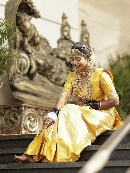 A candid moment of the bride, her natural grace shining through in her custom-designed outfit.