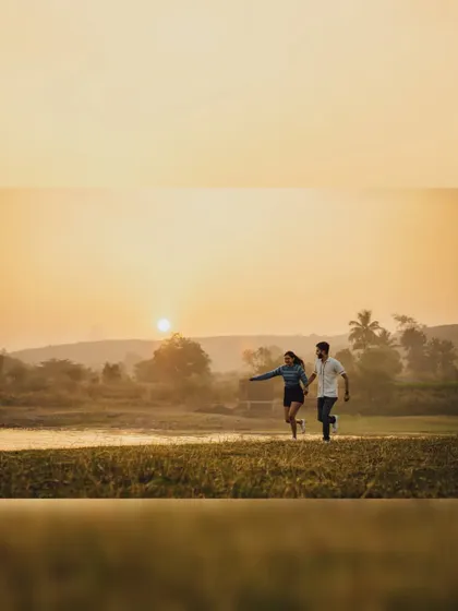 Chasing the sunset together. This golden hour shot from a pre-wedding session captures the couple running hand-in-hand, full of energy and excitement for their future.