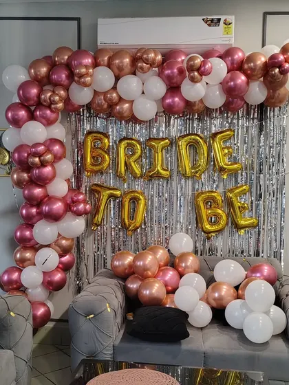 Getting ready for the big day should be fun! We did this chic 'BRIDE TO BE' setup for a pre-wedding party at home, using a rose gold and white balloon garland against a silver shimmer wall for the perfect photo backdrop.