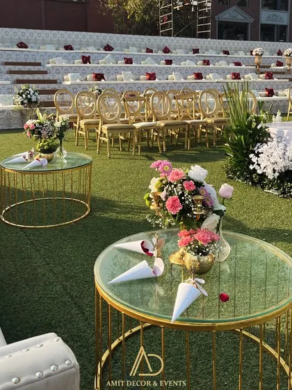 A beautiful detail shot of the guest seating area, with cones of flower petals ready for the celebration, set against the backdrop of the amphitheater and stage.