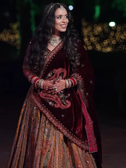 Palak's reception look was all about subtle elegance. Her multi-colored lehenga was paired with a soft makeup look and beautiful open waves.
