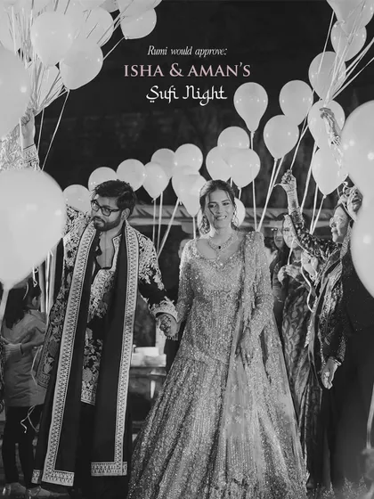 A black and white shot of the couple's entry at their Sufi night, with guests holding up balloons to create a dreamy pathway. Rumi would approve.