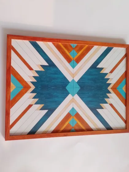 A full view of the geometric blue wood art, showing its rectangular shape and the beautiful symmetry of its design.