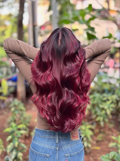 Got red hair and wings. This vibrant, fiery red is for the bold and fearless, styled in beautiful waves to show off its intensity.