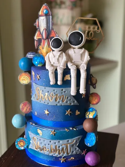 From planets to rockets, this galaxy cake has it all. This two-tiered space-themed cake features handcrafted astronauts and colorful planets to take your celebration to the stars.