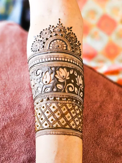 A close-up of the armband, featuring a beautiful band of lotus flowers.
