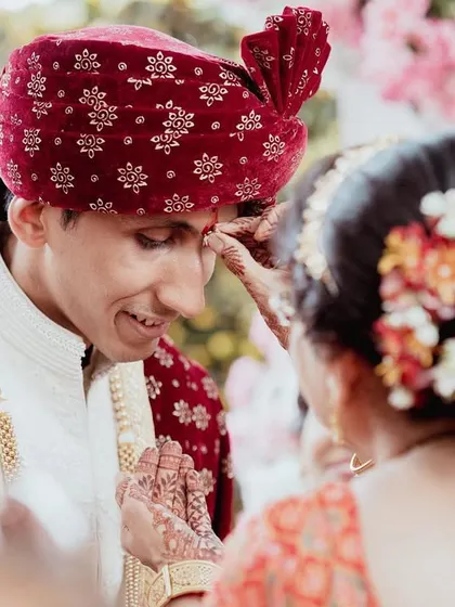 The 'tilak' ceremony, a moment of blessing. We capture these important cultural details with a focus on the emotions involved.