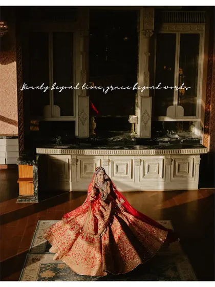 Beauty beyond time, grace beyond words. A wide shot of the bride in a grand, sunlit room, creating a portrait that is both dramatic and beautiful.