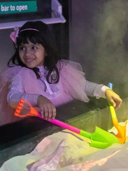 The smile of concentration and fun while playing in the magical illusion sand pit.