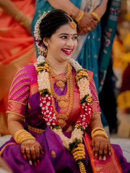 A joyful portrait of the South Indian bride, her wide, happy smile capturing the celebratory spirit of her engagement.