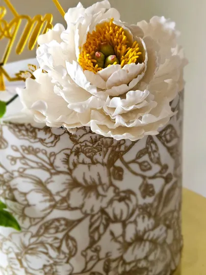 A close-up of the stunning, handcrafted gumpaste peony. Creating these realistic sugar flowers takes hours of work, with each petal shaped and veined by hand.