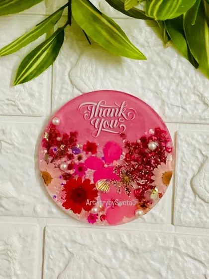 Another view of the pink floral magnet, showcasing the mix of flowers and pearl accents.
