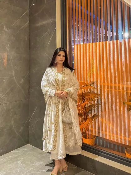 A final, poised shot of the complete white and gold Anarkali look.