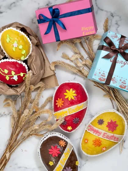 A colourful assortment of our handmade Marzipan Easter Eggs. Each one is uniquely decorated with bright floral patterns and ribbons, making them a beautiful and delicious gift for the Easter holiday.