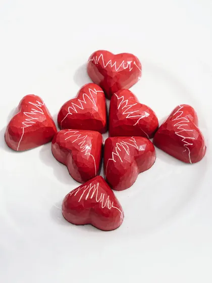 Simple, elegant, and perfect for Valentine's Day. These heart-shaped chocolates on a clean white plate are shot with bright, high-key lighting to give them a modern and sophisticated look.