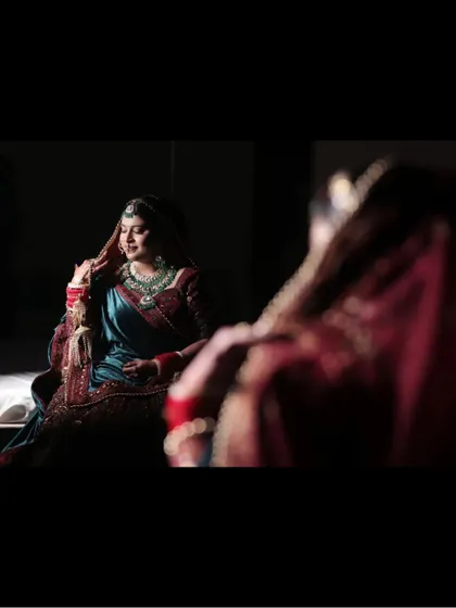 A reflection shot of the bride, capturing her beauty from multiple angles in a single, artistic frame.