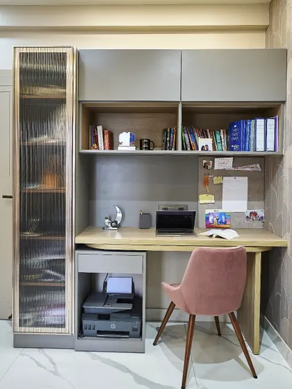 A compact and efficient home office setup, with ample shelving, a dedicated space for a printer, and a comfortable chair for productive work-from-home days.