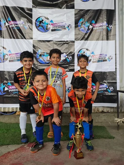 The U7 team celebrating their championship win at the Andheri Premier League.