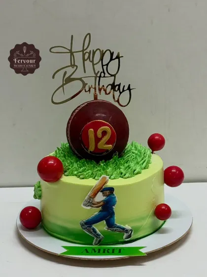 A cricket-themed cake for a 12th birthday. The design features a large edible cricket ball on top of a grassy field made of frosting, with a batsman cutout on the side.