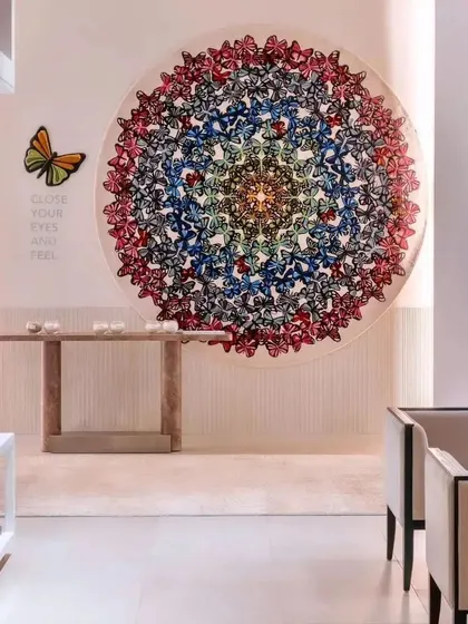 This image from the Hands Carpets store in Mumbai showcases a stunning butterfly-themed carpet, displayed as a circular art piece. The design of the store focuses on creating these "wow" moments, where the craftsmanship of the product is the undeniable centerpiece.