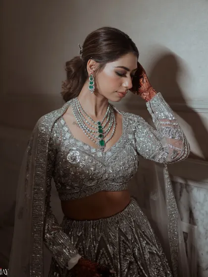 A close-up portrait focusing on the bride's elegant jewelry and serene expression.