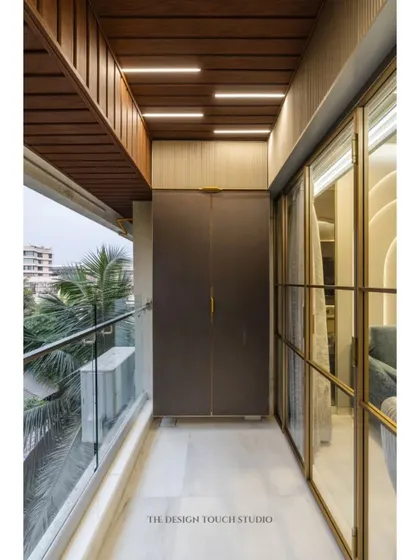 We believe every part of a home deserves great design, including the ceiling. This balcony features a stylish wooden-paneled ceiling with integrated linear lighting, adding warmth and a modern touch.