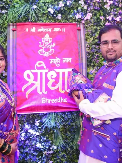 The proud parents revealing the baby's name, "Shreedha," at the naming ceremony.